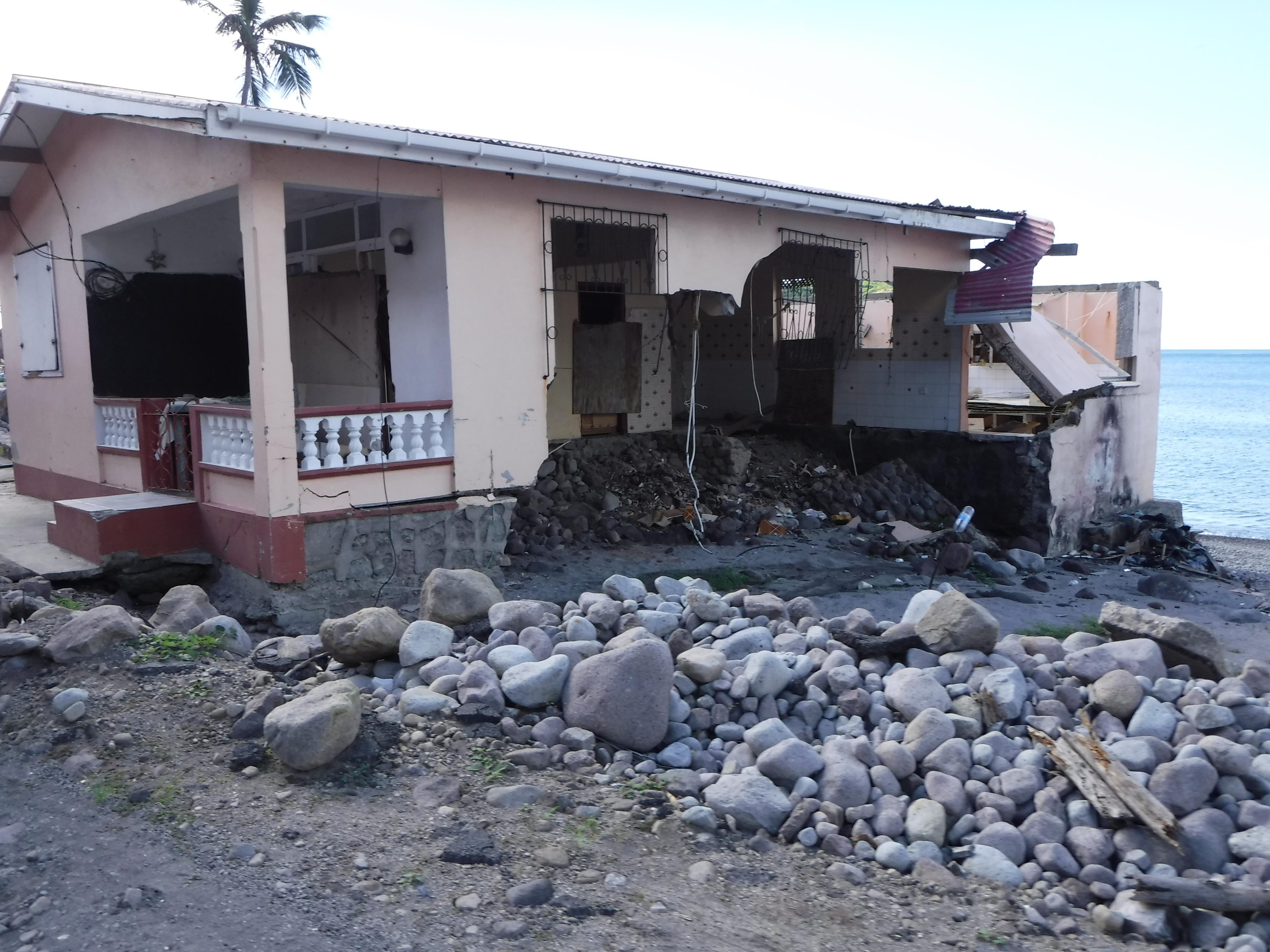 house destroyed and with rubble in front