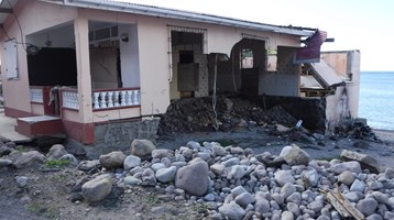 house destroyed and with rubble in front