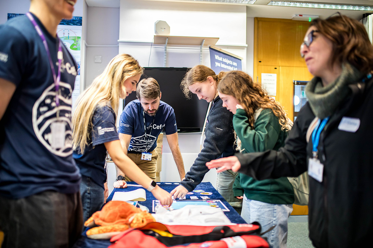 Students pointing to information on table