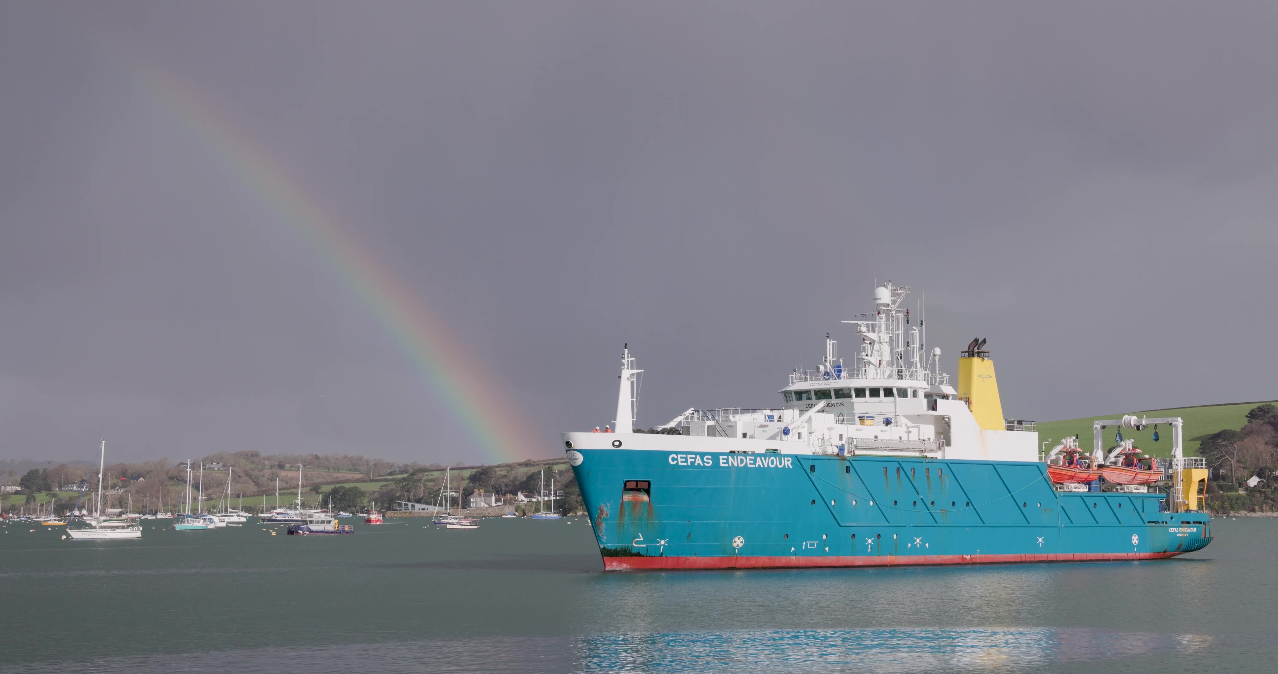 Cefas endeavour coming into port with a rainbow in the background