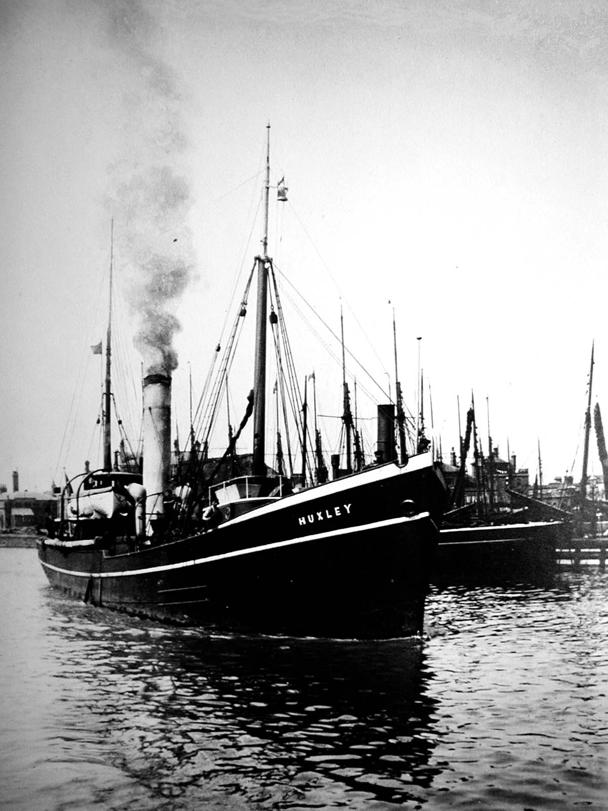 an old photo of boats in a habour