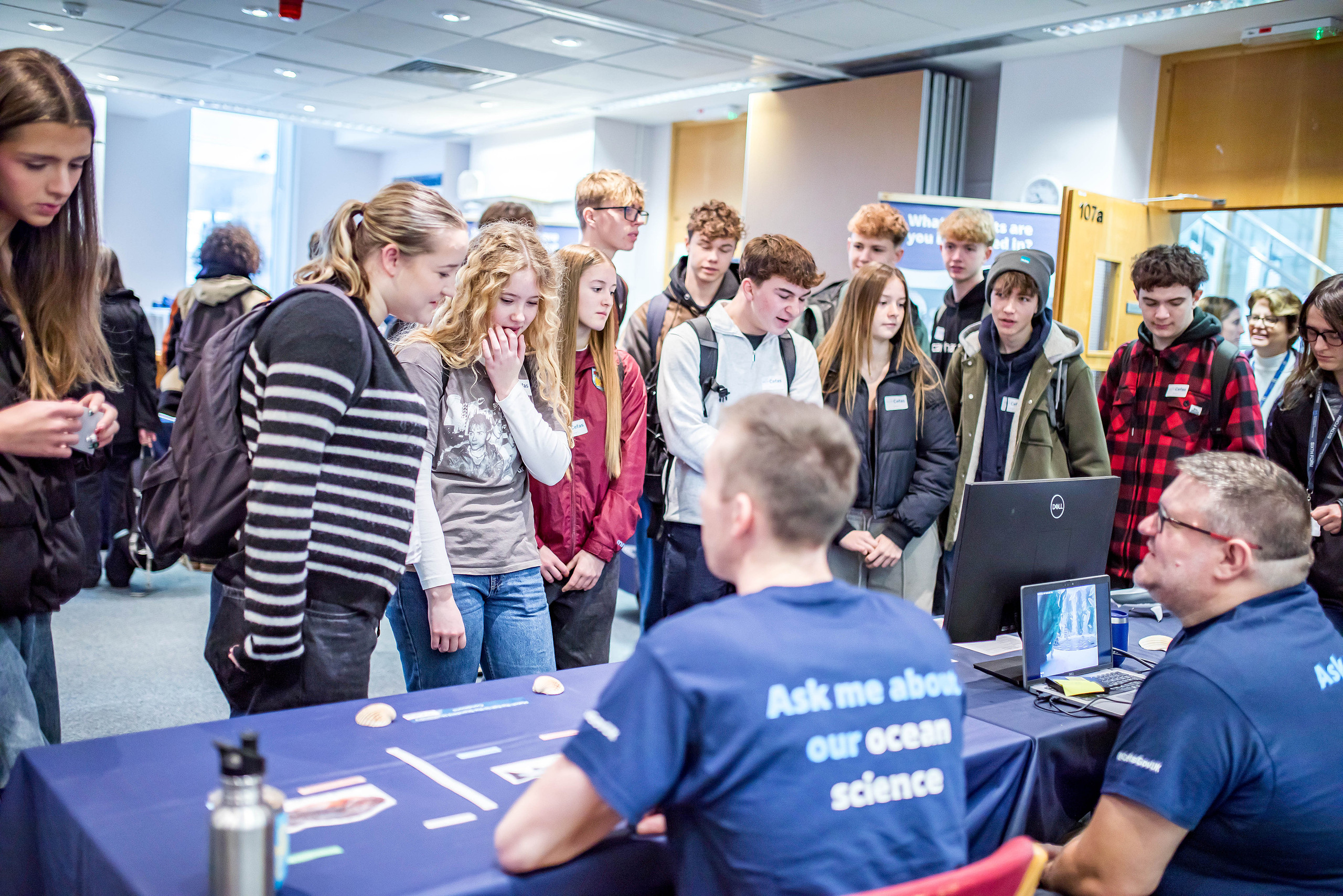 Students looking at information about Cefas science