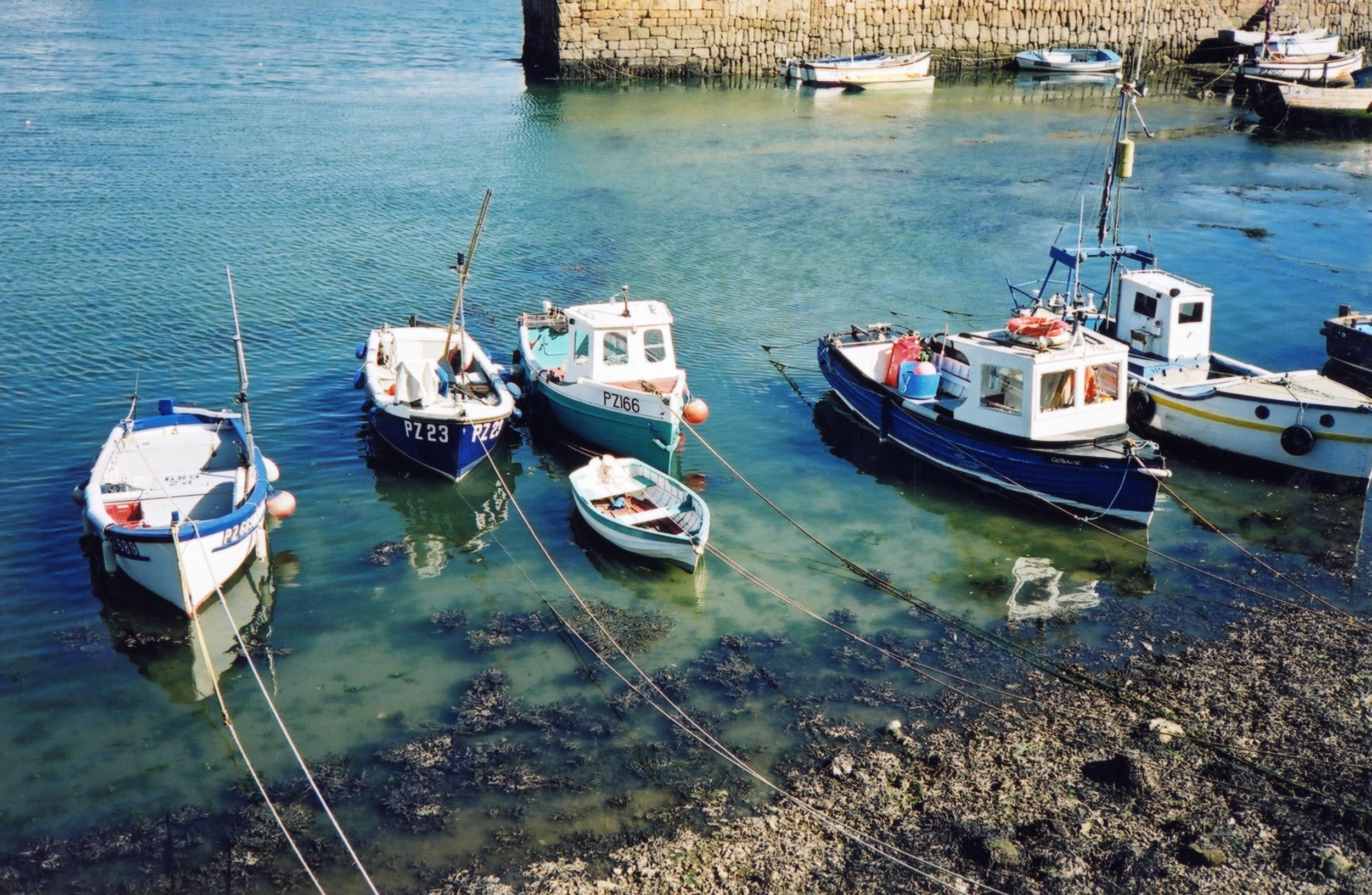 fishing boats in shallow water next to beach