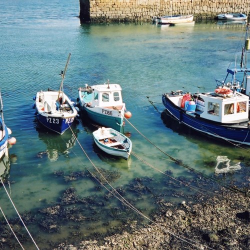 fishing boats in shallow water next to beach