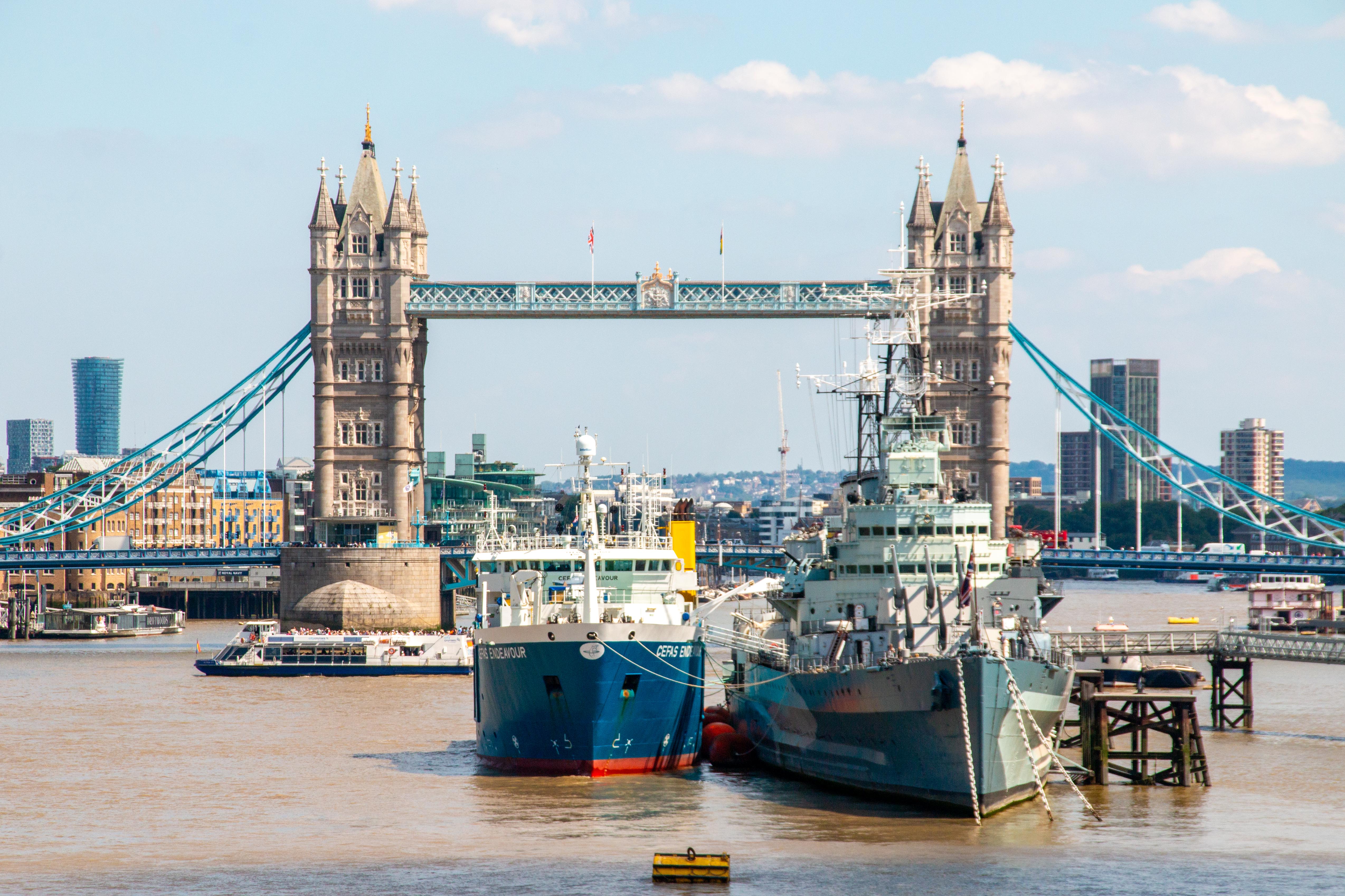The Cefas Endeavour docked on the Thames in front of London Bridge on a clear, sunny day in London