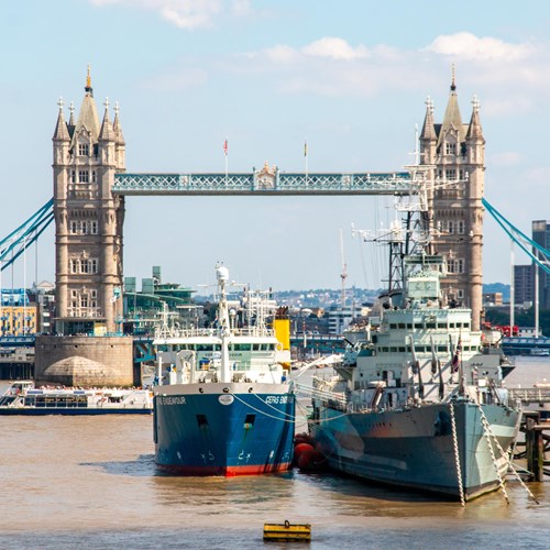 The Cefas Endeavour docked on the Thames in front of London Bridge on a clear, sunny day in London