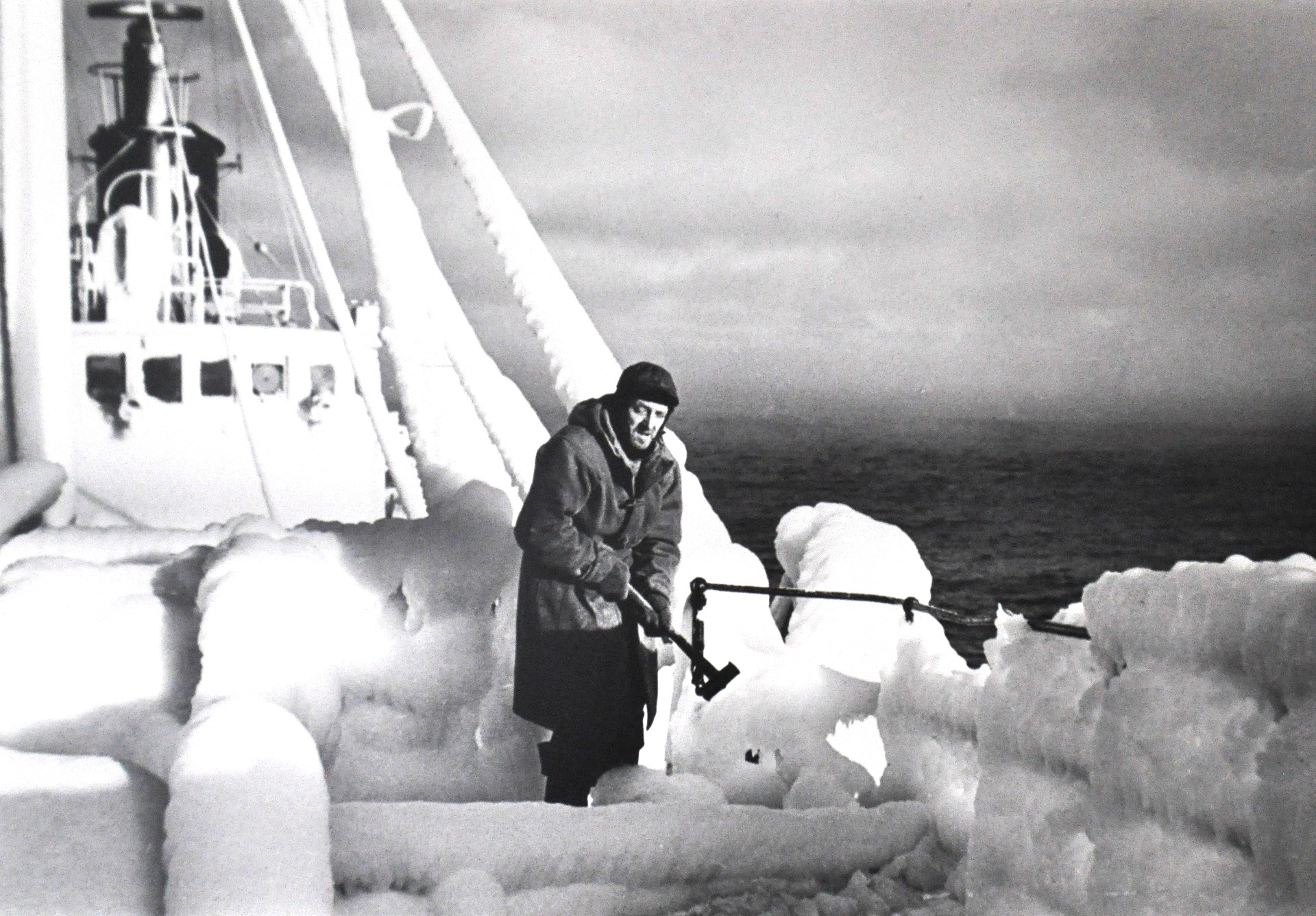 a person on a boat surrounded by ice
