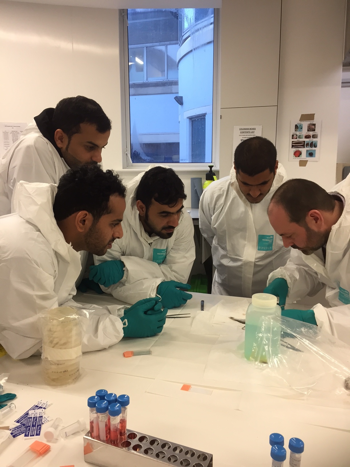 men looking at a test tube and beaker