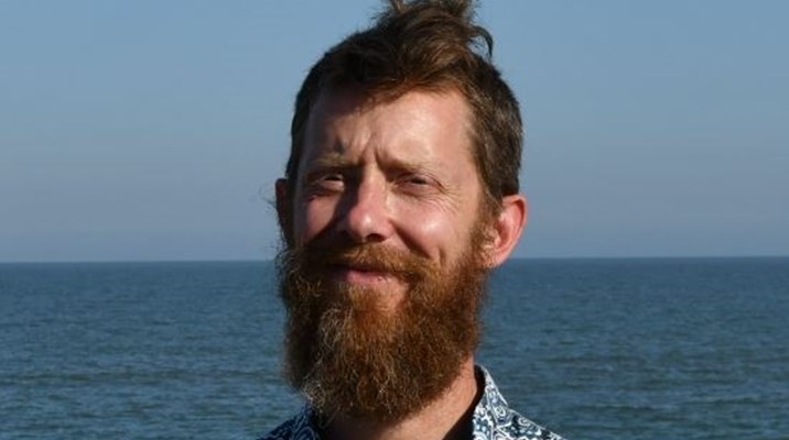 a man on a beach by the sea