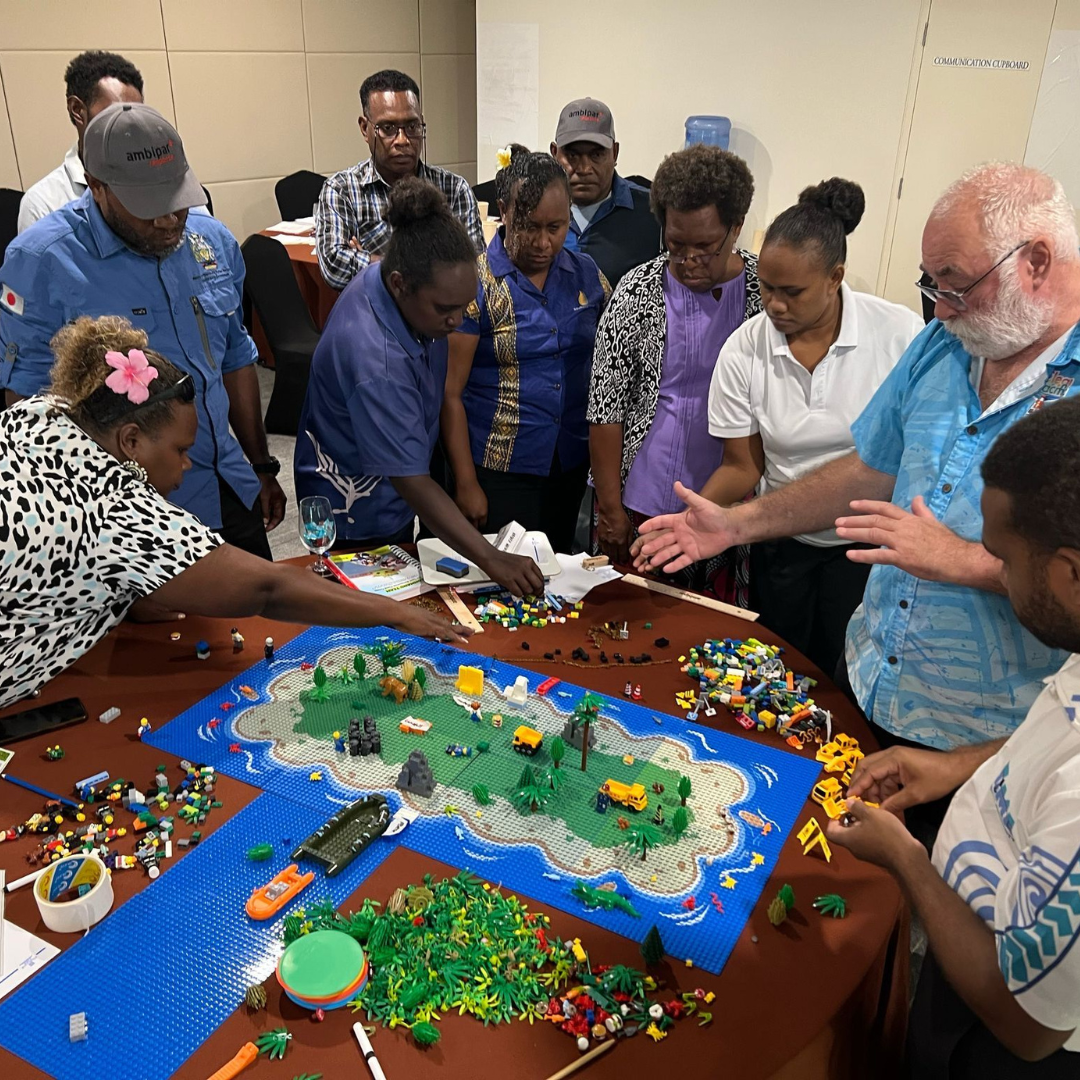 a group of people in various uniforms partaking in a table top exercise about marine environments