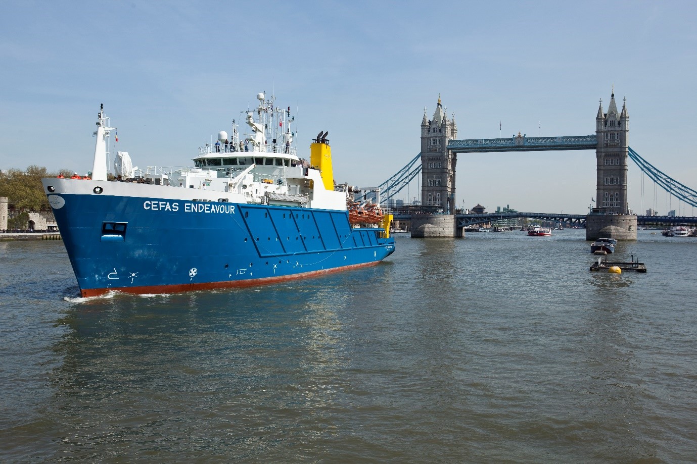 boat in front of bridge