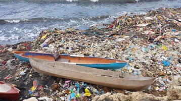 2 boats on litter on a beach