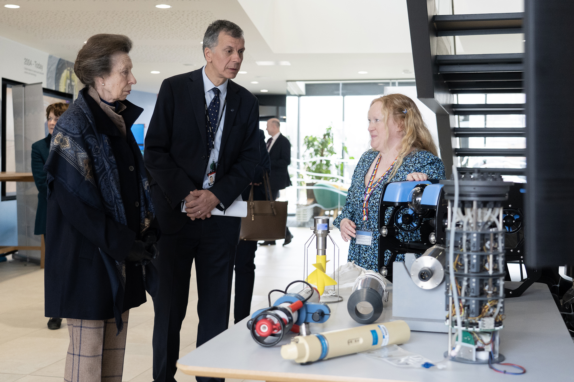 The Princess Royal with Cefas Chief Scientist, Stuart Rogers and Cefas Marine Engineer, Annie Meadows and a demonstration of marine monitoring equipment.