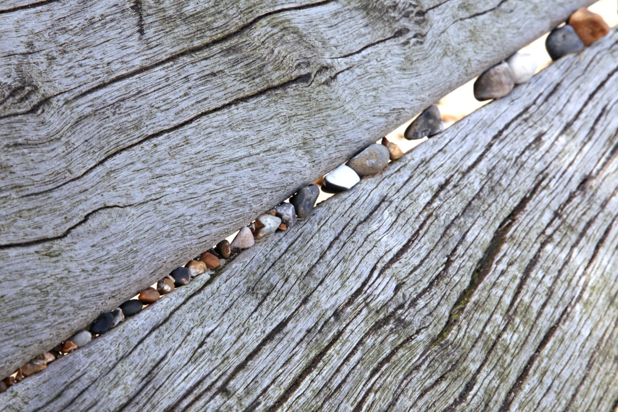 stones between two pieces of wood