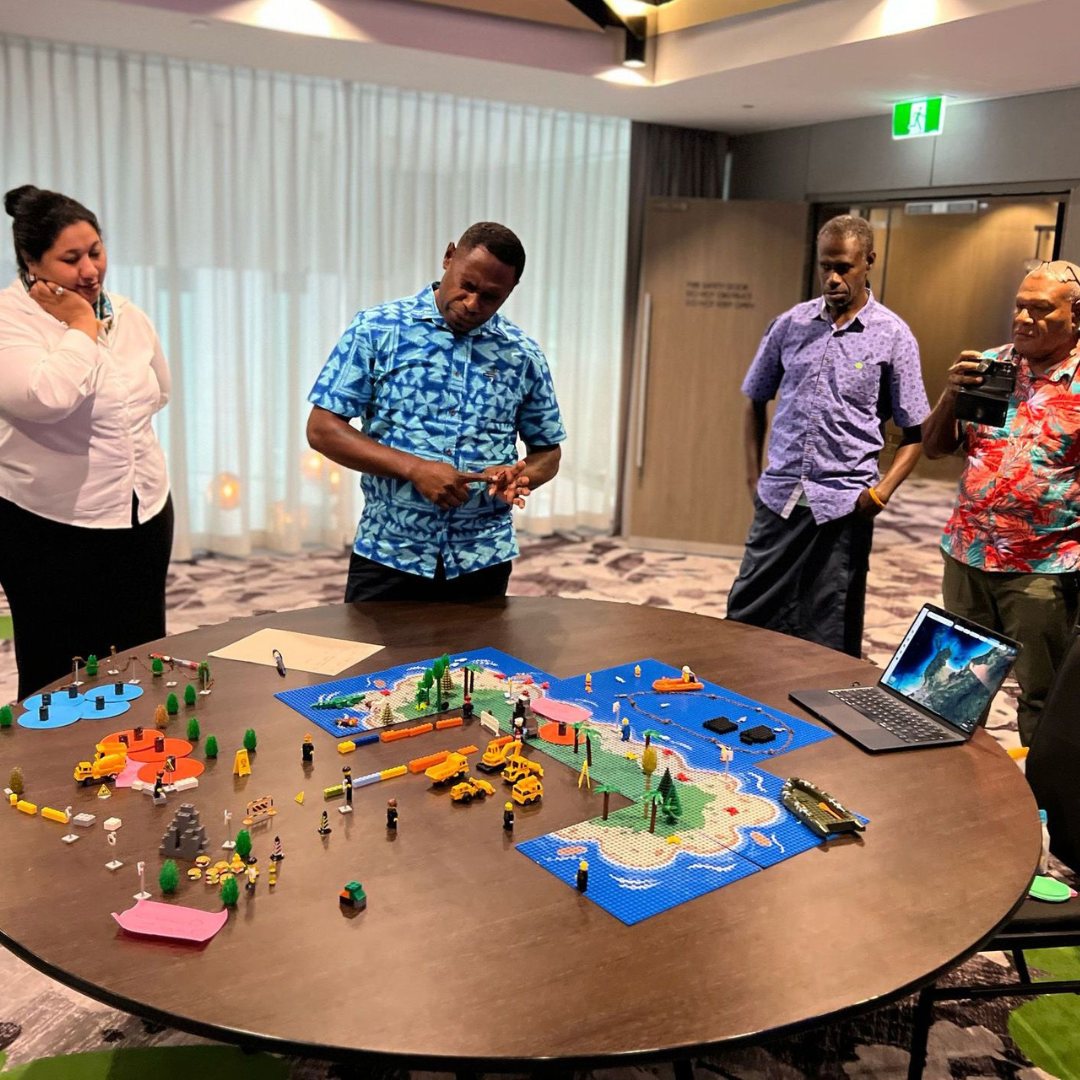 participants standing around a table partaking in a table top exercise on emergency response training