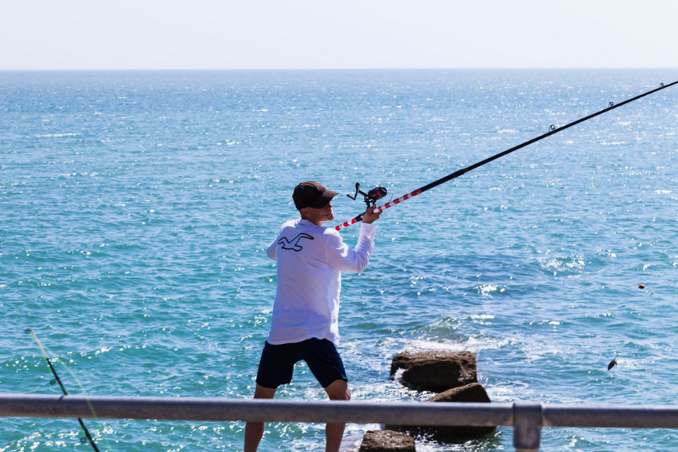 man sea angling with line and rod