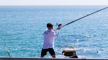 man sea angling with line and rod