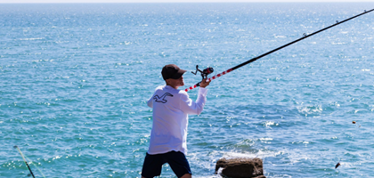 man sea angling with line and rod