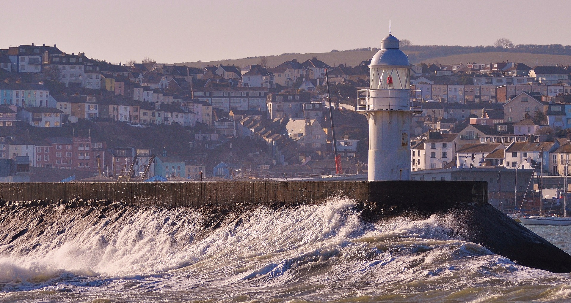 a lighthouse being hit by waves